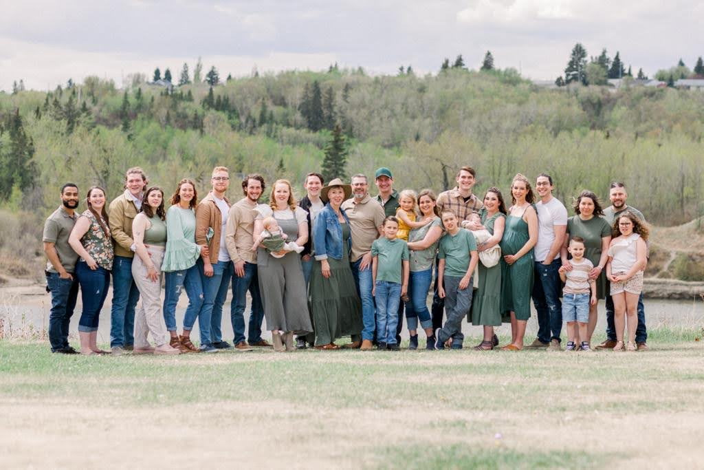 Mother–daughter doulas with family in warm natural light