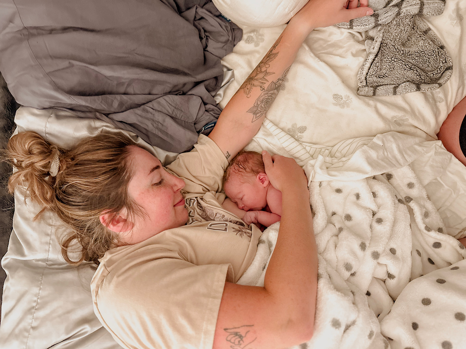 Mother holding newborn close